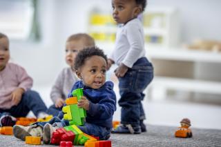 Play to Learn, Learn to Play Toddlers playing with big legos.