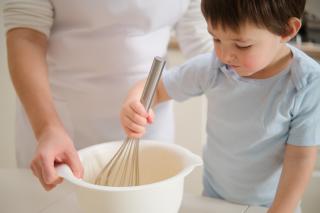 Preschooler helping his father with Thanksgiving dinner. 