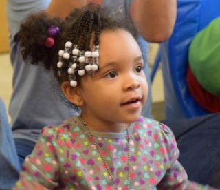 African-American toddler girl with ponytail and hair beads