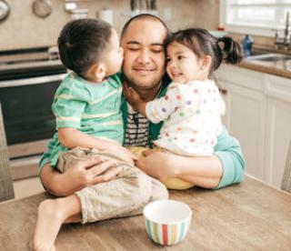 Kids hugging a father