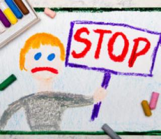 Colorful drawing: Sad boy holding a STOP sign in his hand 