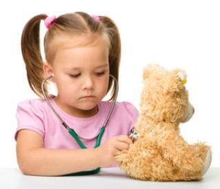 little girl is examining her teddy bear using stethoscope, isolated over white