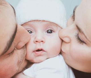 young mother and father with newborn