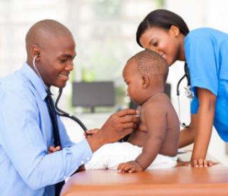 African american male pediatric doctor examining baby boy with female nurse