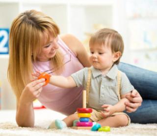 cute mother and child boy play together indoors at home