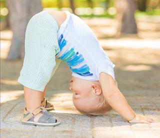 Baby doing Downward Facing Dog pose.