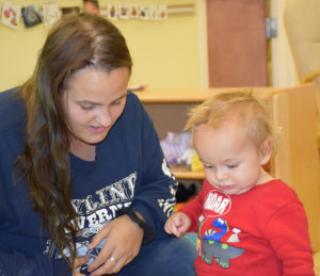 Mother and baby work on a task together 