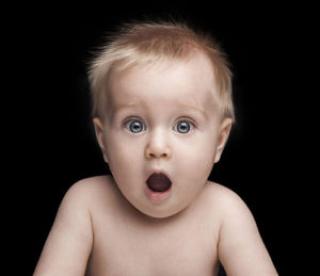Infant portrait with funny shocked face expression