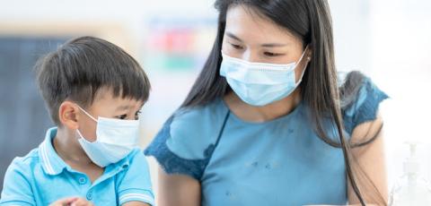 Masked provider and toddler. Masked provider and toddler.