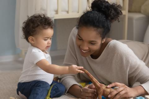 A female in home child care provider with little boy. 