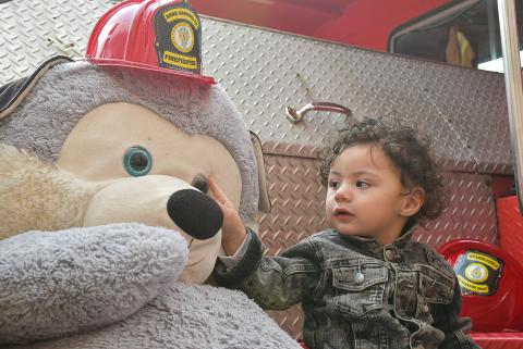 Little boy and fire fighter bear. 