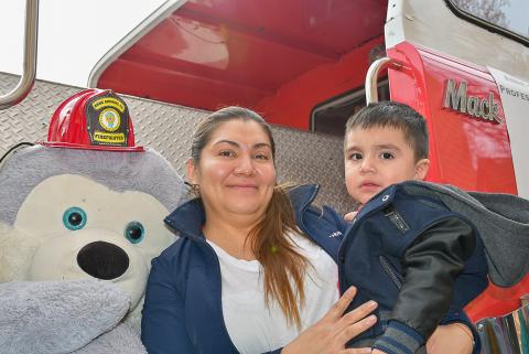 Mom and son on fire truck.