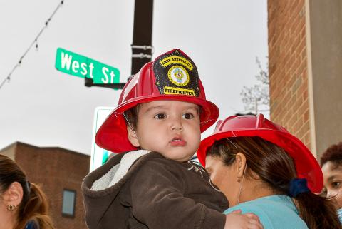 Toddler in firefighter had. 