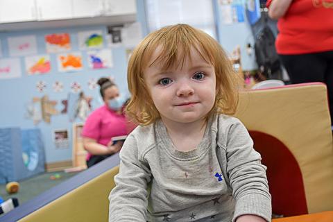 Happy red haired girl in quality child care. 
